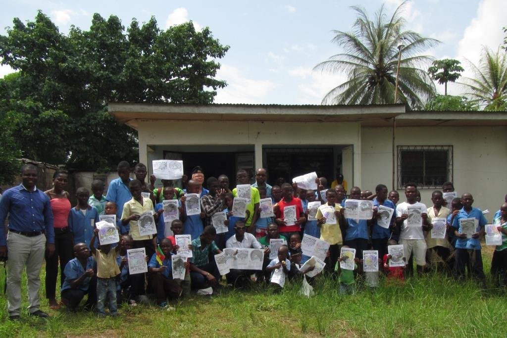 Students with manatee coloring books in Dizangue, Cameroon